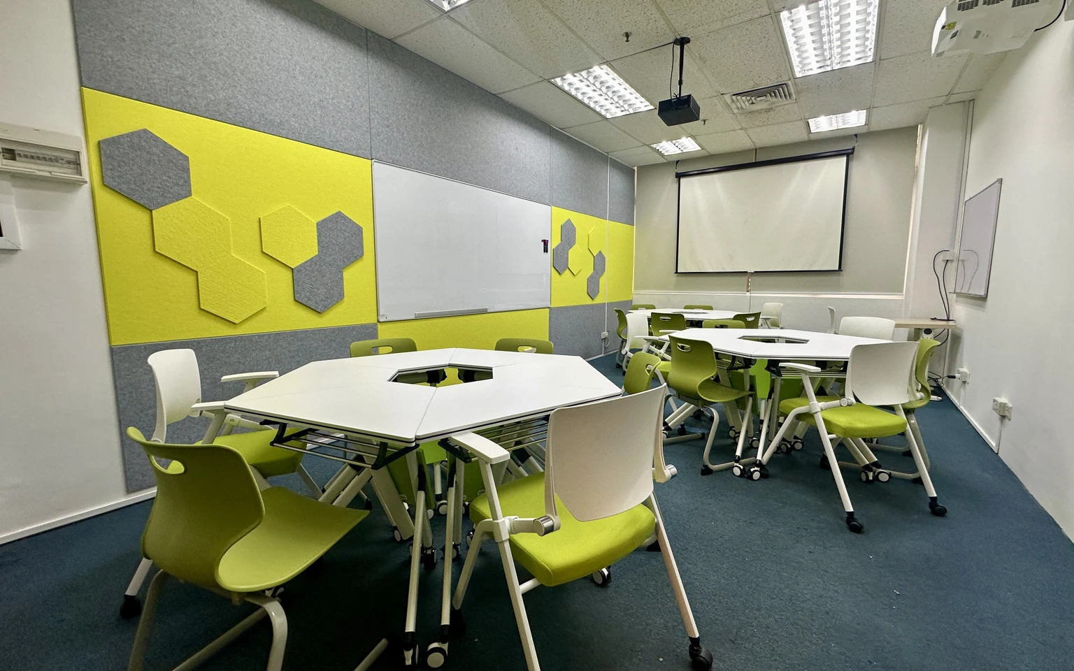Inside Room #03-03: desks and chairs arranged for a class.