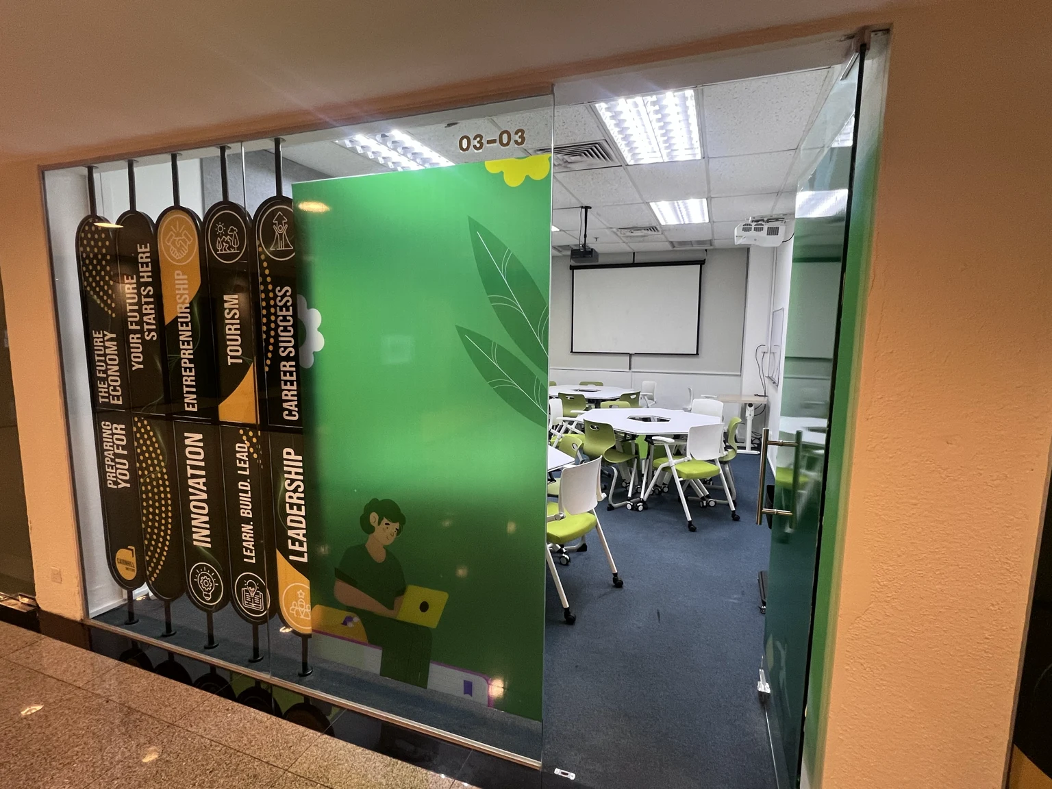 Room #03-03 seen through its glass front, with the unit signage above.